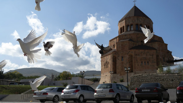Pigeons fly near Holy Mother of God Cathedral in Stepanakert during a military conflict in the separatist region of Nagorno-Karabakh.