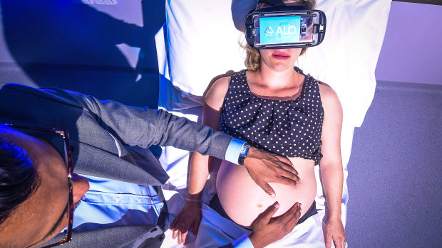 Elizabeth Deitz wears a VR headset as she settles in for the procedure.