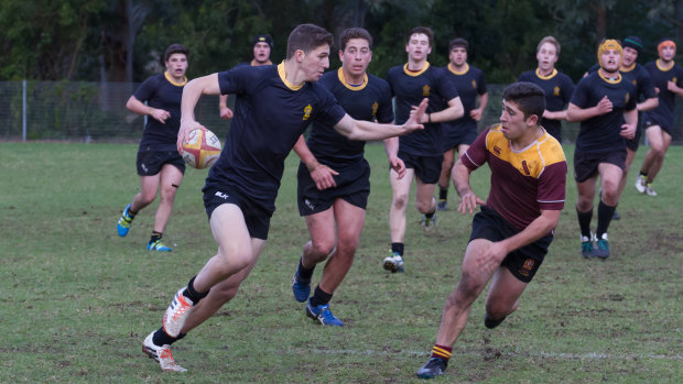 A 14-year-old Nawaqanitawase runs support for Adam Doueihi with St Patrick's College Strathfield's 1st XV in 2016.