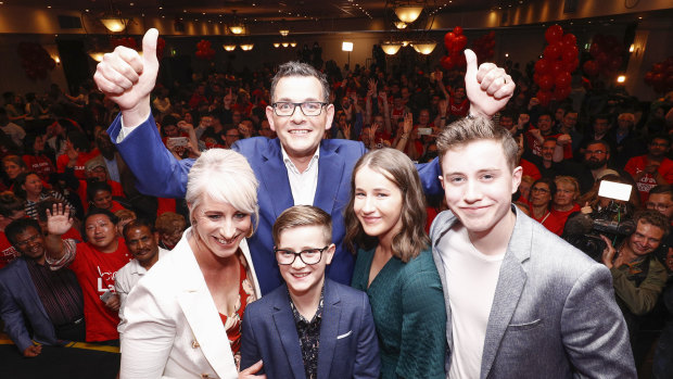 Premier Daniel Andrews (top) poses for a photo with his family during the Labor Party celebrations