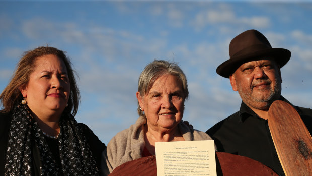 Megan Davis, Pat Anderson and Noel Pearson with a piti holding the Uluru Statement from the Heart in May 2017.