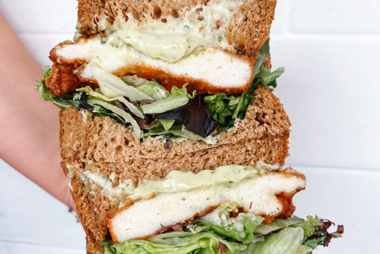 Schnitty sandwich with crispy chicken schnitzel, herby mayonnaise, mixed lettuce and caramelised carrot.