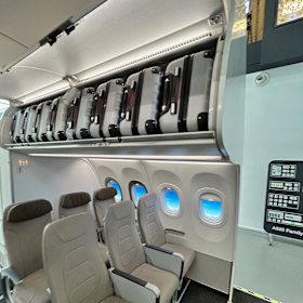 The new cabin bins on Qantas planes will fit four 10kg wheelie bags - vertically.