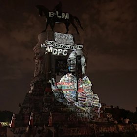 The image of Marcus-David Peters,  who was shot by a police officer in 2018, is projected onto Lee's statue in Richmond.
