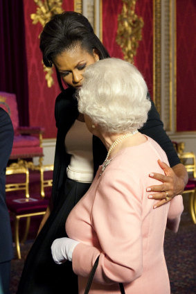 Michelle Obama, wife of US President Barack Obama, left, walks with the Queen. 