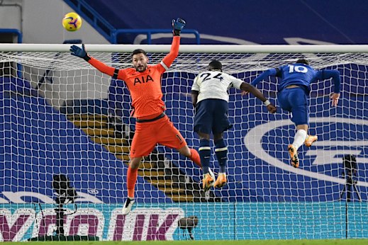 Spurs goalkeeper Hugo Lloris jumps for the ball against Chelsea along with teammate Serge Aurier (centre) and Christian Pulisic of the Blues.