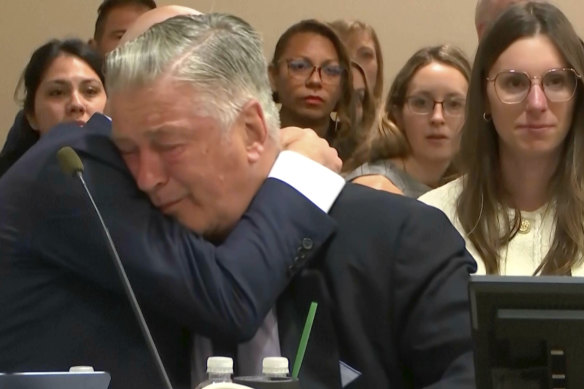 Alec Baldwin hugs one of his attorneys after a judge threw out the involuntary manslaughter case against him in July.