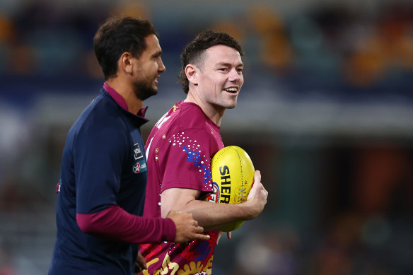 Callum Ah Chee and Lachie Neale of the Lions warm up.