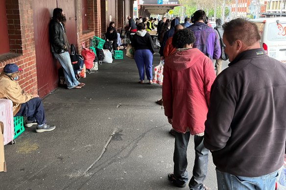 People queue for food outside Queen Victoria Market in Melbourne.