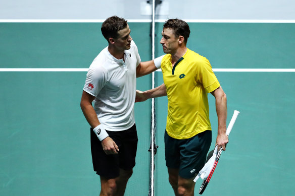 Canadian Vasek Pospisil, left, acknowledges a disappointed John Millman after their match. 