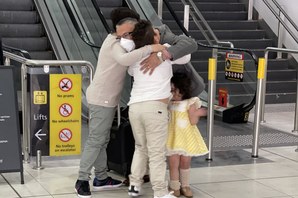 The El Nabbout children reunite with their father at Melbourne Airport on Saturday.