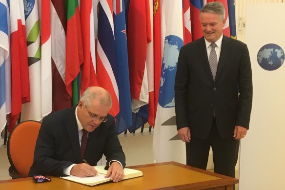 Prime Minister signs the guest book at the OECD, overseen by new Secretary-General Mathias Cormann.