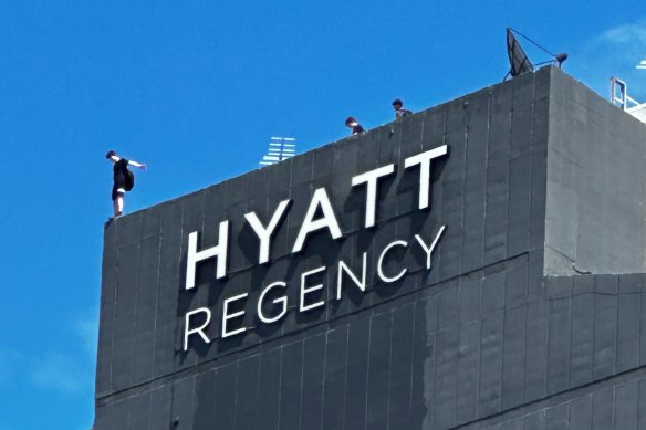 Dangerous skylarking on the rood of the Hyatt Regency in Brisbane.