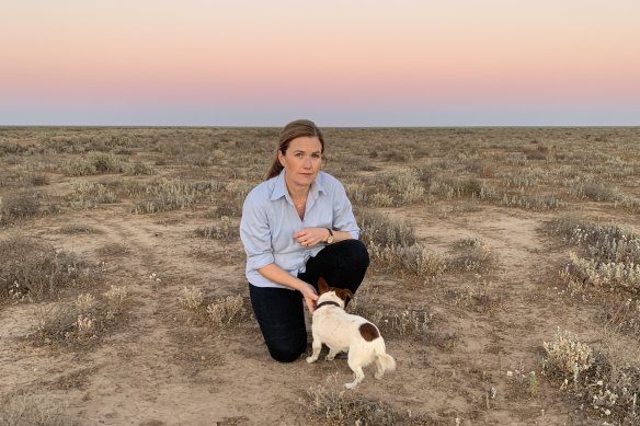 Alison McLean and her dog Gary in a paddock on her drought-stricken sheep farm 100 kilometres north of Hay.