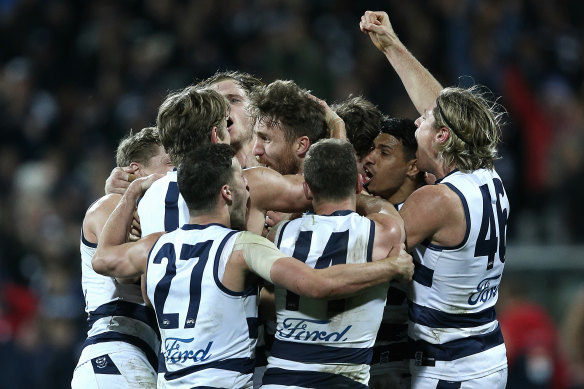 The Cats get around Zach Tuohy after his match-winning goal against Melbourne.