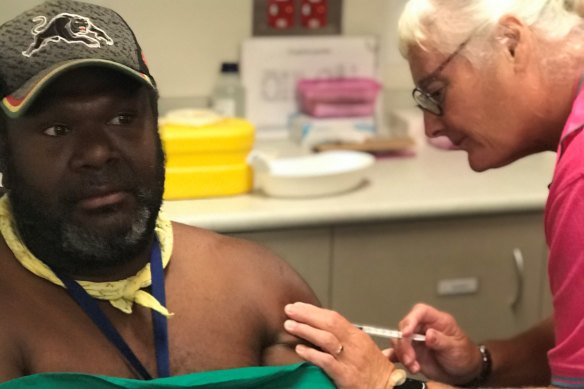 Saibai Island councillor Conwell Tabuai is vaccinated by nurse Sue Bowler.