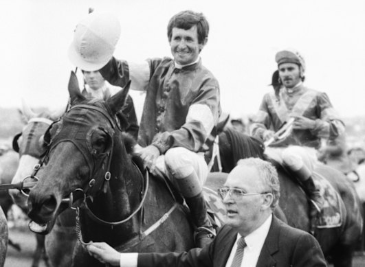  Co-owner, Dennis Gowing, leads Melbourne Cup winner, What a Nuisance with jockey Pat Hyland. 
