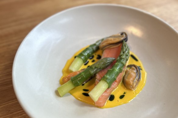 Salmon with asparagus and mussels at La Cachette, which writes new menus every three weeks.