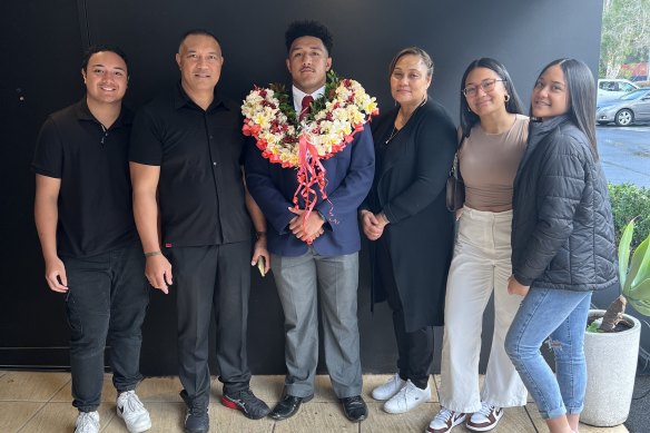 Rising Bulldogs star Paul Alamoti (centre) with his family, including dad Soane (second from left).