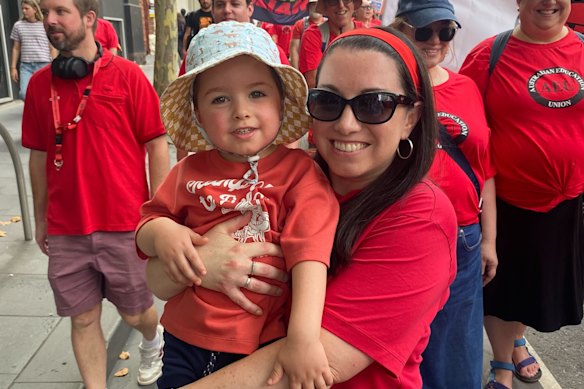 Blackburn Primary School teacher Michelle Fabris with her two-year-old son at the rally in Melbourne’s CBD.