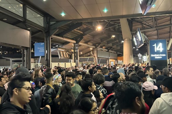 Commuters wait to get onto train platforms at Southern Cross Station in the early hours of 2024.