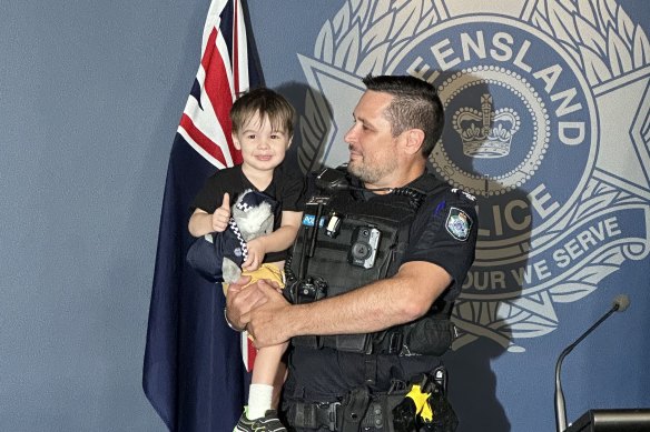 Ethan Hopper with Senior Constable Stuart Power, who rescued the three-year-old after he became trapped in a toy claw machine at a Capalaba shopping centre.