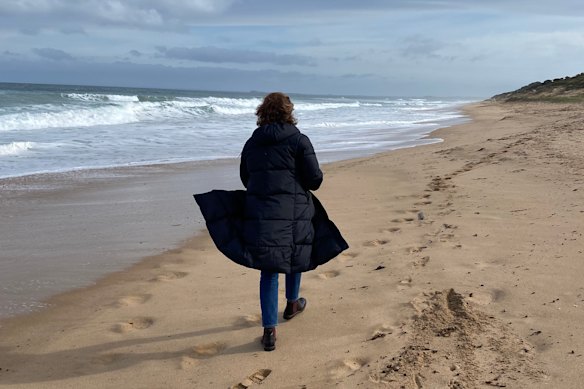 The author scattering her dad’s ashes on the beach.
