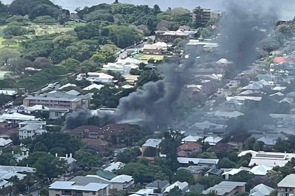Smoke billows from the unit on Lower Bowen Terrace in New Farm on Sunday morning. 