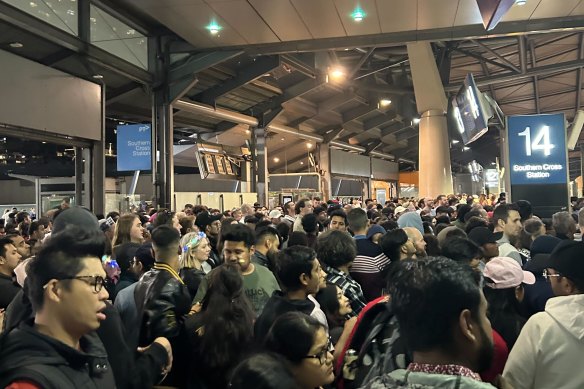 Commuters wait to get onto train platforms at Southern Cross Station.