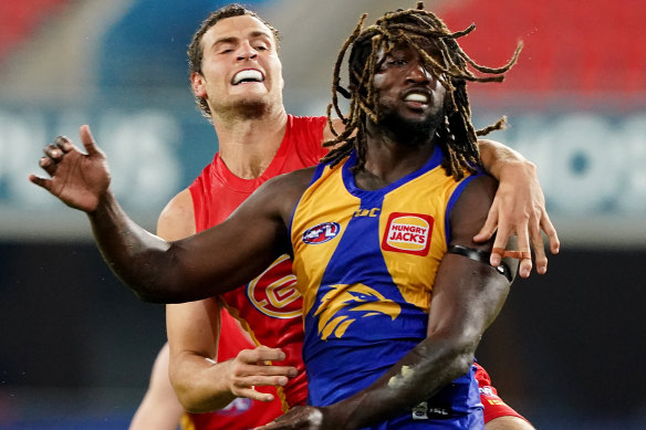 Jarrod Witts, left, and Nic Naitanui, right, clash. 