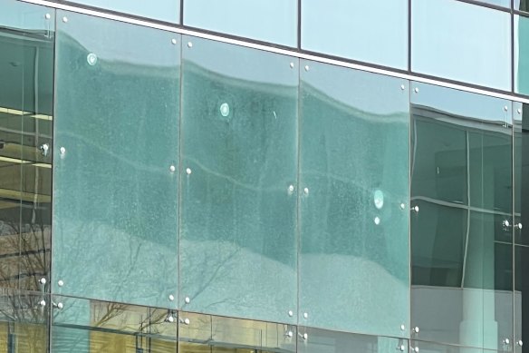 Gunshot damage visible in the windows of Canberra Airport.