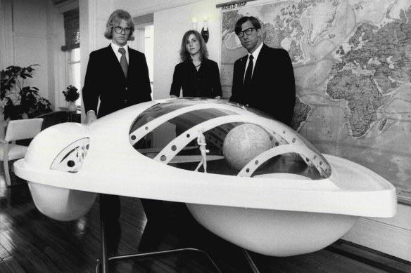 Three members of the Embassy, (l to r) Robert Perry, Alex Morphett and Doug Michels with a model of the research craft.