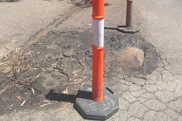 A burst water main leaked undetected for six to eight weeks, potentially causing upwelling and cracking in the roads.