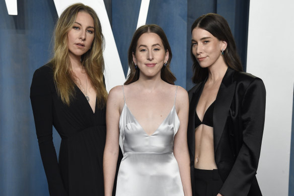 Este Haim, from left, Alana Haim, and Danielle Haim arrive at the Vanity Fair Oscar Party in 2022.