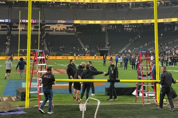 Ground staff take down rugby league posts 20 minutes after the match.