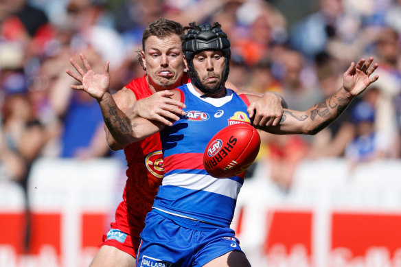 Caleb Daniel fights for the ball with typical ferocity on Sunday against Gold Coast’s Nick Holman.