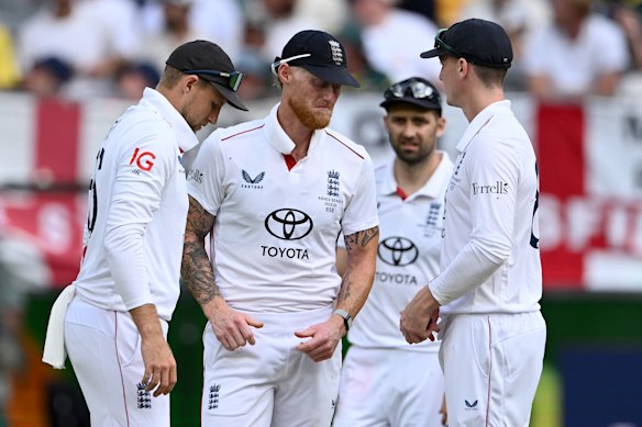 England captain Ben Stokes speaks with Joe Root and Harry Brook in Perth.