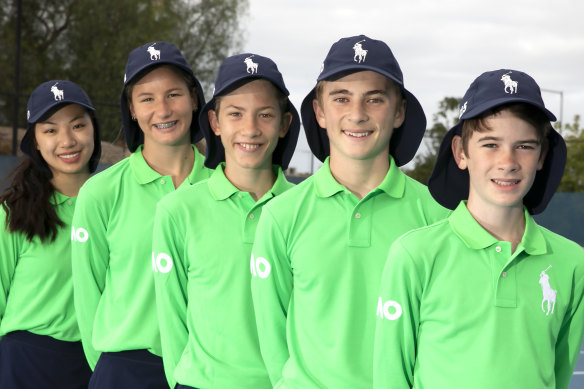 Maddie Higgins (second from left) lines up with fellow ball kids at Xavier College on Wednesday.