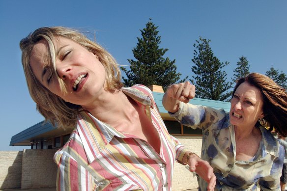 Irene (Lynne McGranger) punches Angie (Laurie Foell) when she discovers what she has been doing to Nick (Chris Egan).