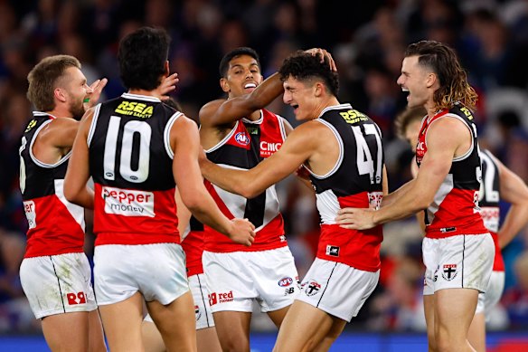 St Kilda teammates get around goalkicker Anthony Caminiti. 