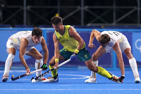 Belgium’s Arthur Van Doren and Antoine Sylvain T Kina battle for possession with Australia’s Tim Brand.