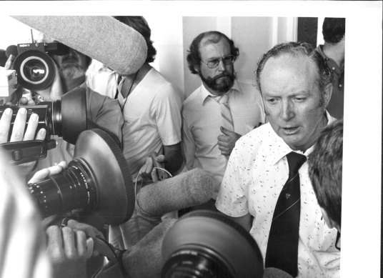 State Secretary of the ARU Jim Walshe, beseiged by media after his members voted to stay out on strike at a meeting held at Parramatta Town Hall. February 17, 1982. 