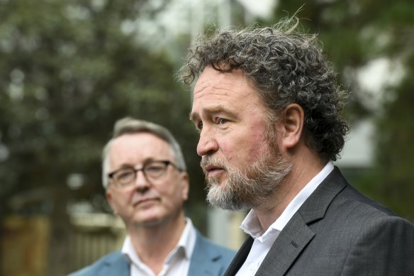 Professor Ben Cowie (right) speaks on Sunday as Health Minister Martin Foley looks on. 