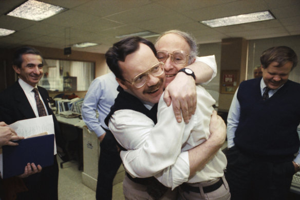 Former hostage and Associated Press Middle East chief correspondent Terry Anderson, centre left, hugs colleague Jim Abrams during a visit to the Washington bureaus of The Associated Press in Washington, 1991.