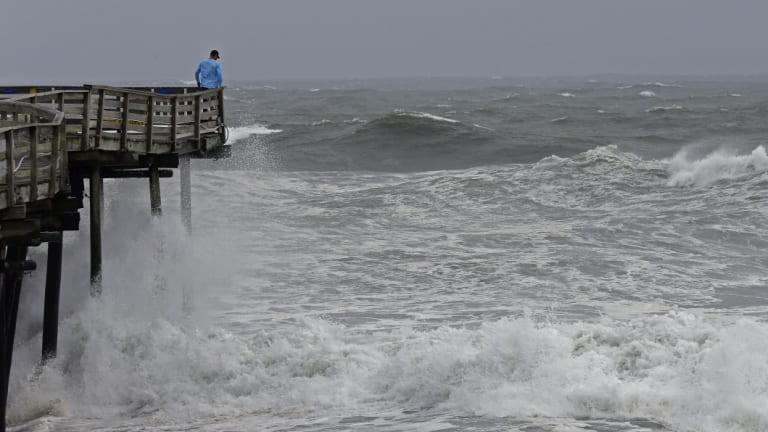 An onlooker checks out the heavy surf at the Avalon Fishing Pier in Kill Devil Hills.