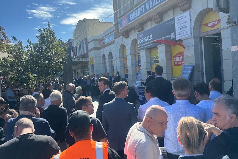 Crowds at Oakleigh’s Eaton Mall on Thursday morning gather for the auction of the Chemist Warehouse outlet.