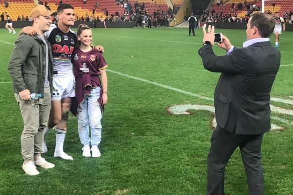 Happy snap: Queensland coach Kevin Walters takes a picture of his son Jett and a friend with Nathan Cleary.