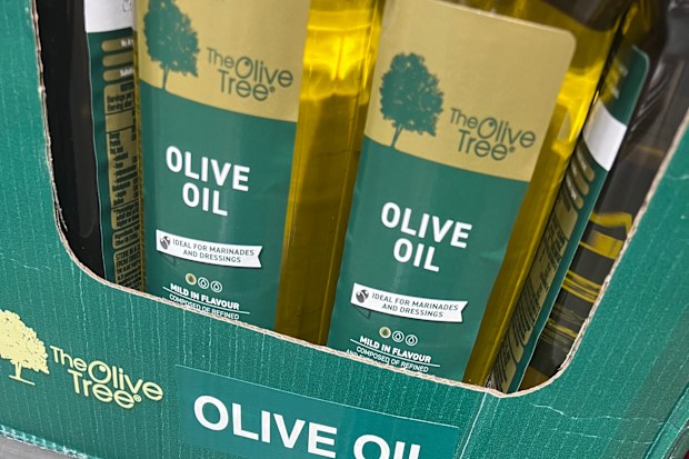 Bottles of olive oil on a supermarket shelf.