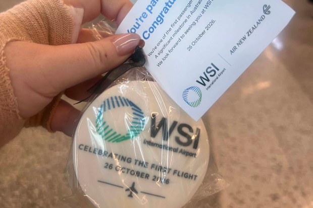 Staff are handing out souvenir cookies and water bottles as well as colourful lamingtons at Western Sydney Airport.