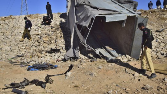 Pakistani security officials inspect a damaged truck at the site of suicide bombing on the outskirts of Quetta, Pakistan, last month. A suicide bomber hit near a truck carrying police officers on their way to protect polio workers outside Quetta.
